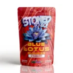 Stoned To Go Blue Lotus Gummies in strawberry flavour by Cannashock, featuring a 6000mg package with psychedelic patterns and a prominent blue lotus flower, emphasizing a refreshing and intense edible experience.