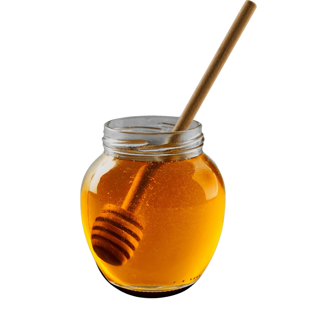 Jar of golden honey with a honey dipper and honeycomb on the side, showcasing rich texture and natural sweetness